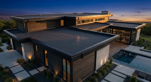 Modern luxury residence with dark flat roof at golden hour
